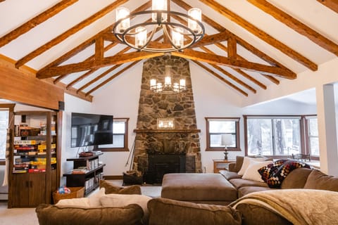 Large living room area with comfortable sectional, TV, fireplace, and games! 