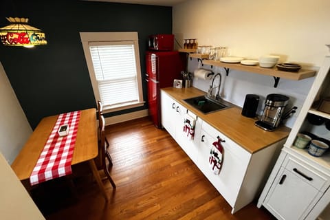 Kitchenette - coffee station, cooktop and toaster oven, pots and pans, utensils.