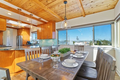 Gather and feast at our 8-seater kitchen table, offering a perfect blend of homely comfort and beachside dining with a view.