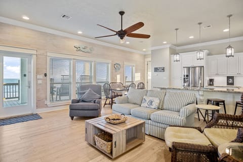 Beach Breeze Living Area: Plenty of seating for guests, with tons of windows to capture the views. 