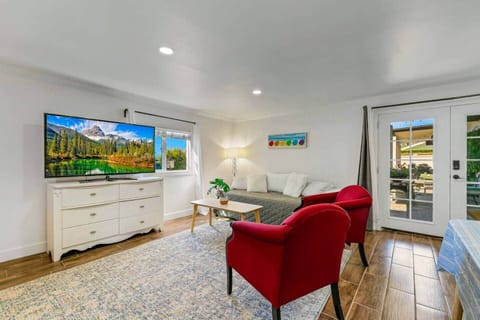 Large guest studio, Samsung smart TV, couch, and chairs. Open concept layout. Windows with natural light and ocean breezes.