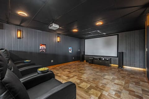 The theater room is furnished with comfortable recliners, providing a truly relaxing experience. Additionally, there is an extensive collection of movies available for the DVD player.