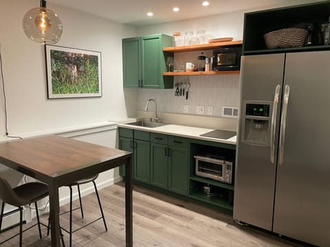 A counter height table offers extra space for meal prep or sit/stand work.