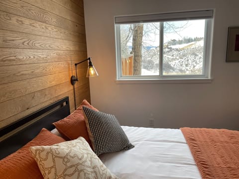 Valley views from your queen bed. The shade has blackout and privacy options.