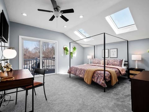 Cozy bedroom w/ bed, soft lighting & ceiling fan for added comfort