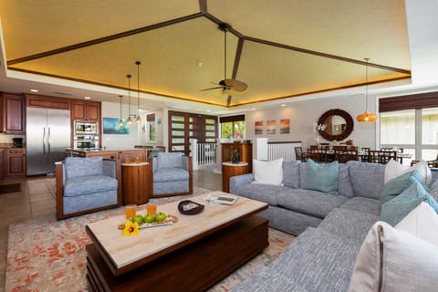 Large new sectional and swivel chairs in living room with vaulted ceiling