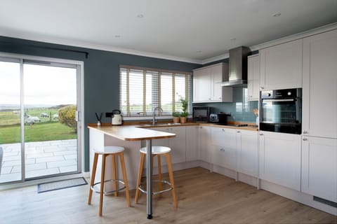 Overthickside Cottage - shaker style kitchen with breakfast bar and two stools