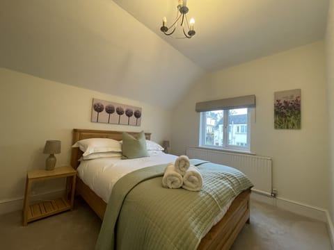 This bedroom is furnished with double bed, wardrobe and bedside tables