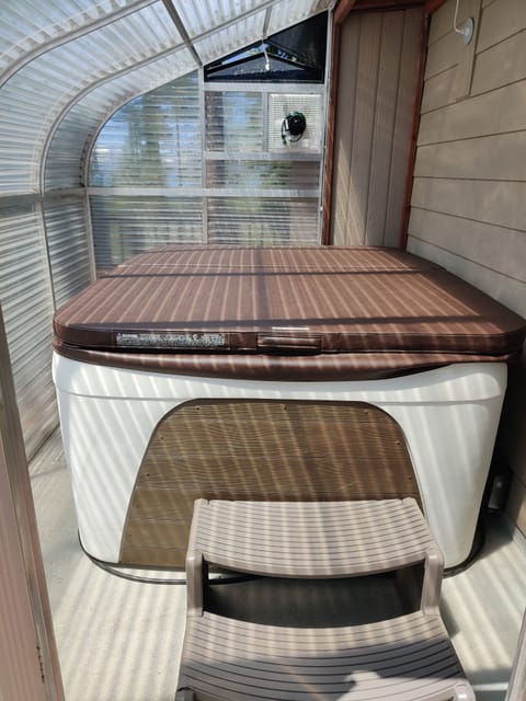 Hot tub located in solarium doubling as a sauna!