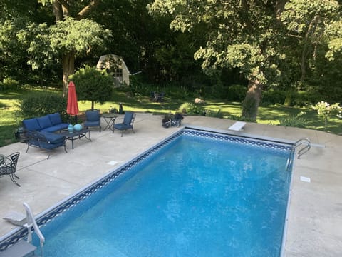 Backyard, heated pool with large patio and seating