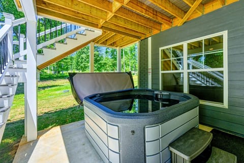 Relax in the private hot tub located under a covered patio