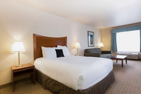 Sink into plush bedding and unwind by the sunny seating area.