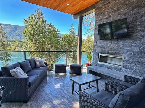 Patio with outdoor seating, fireplace and TV