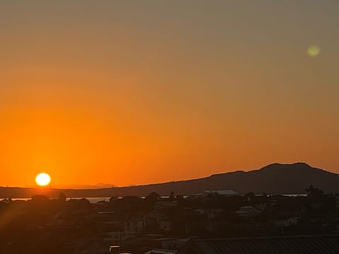 Sunrise over Rangitoto Island (volcano) from main deck & kitchen/dining/lounge