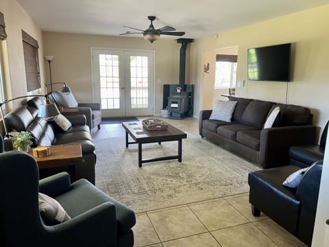 Living room space has many seating options and a Smart TV