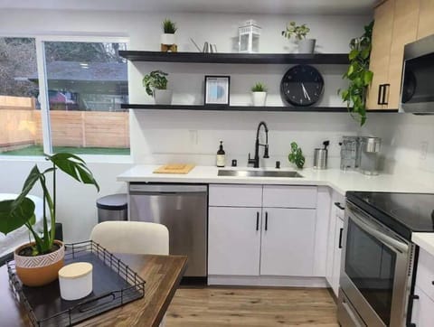 full sized kitchen w/ dishwasher, oven, microwave, and large fridge