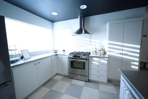 Sunny kitchen with skylight tube, pantry cabinet storage