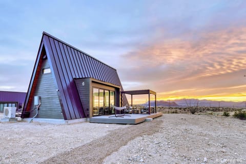 Exterior view of A-Frame #6 with a gorgeous sunrise behind the Chisos Mountains