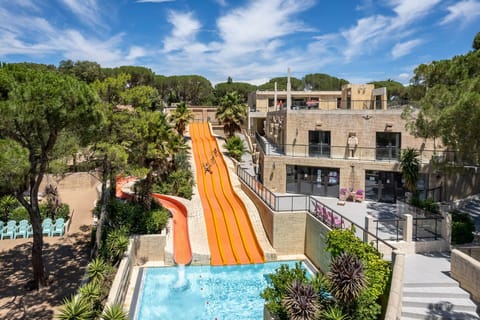 Excitement awaits with a thrilling water slide plunging into a refreshing pool.