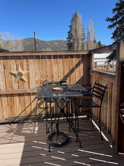 Outside porch area with table and grill