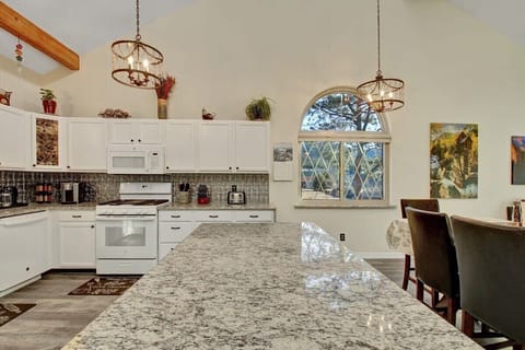 Large kitchen with granite countertops, huge island and lots of prep space