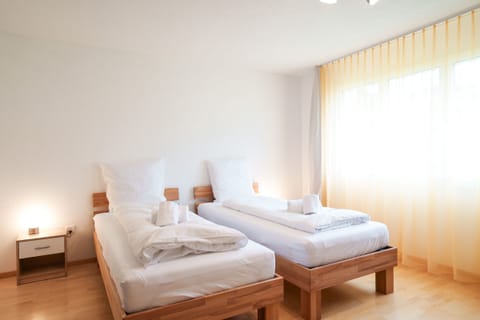 The bright bedroom has two single beds