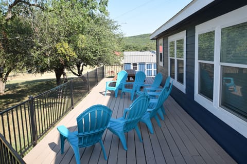 Large deck with dining table and lounge chairs