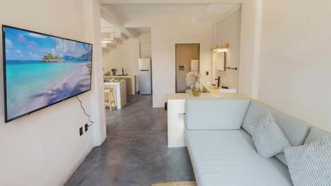 Stretch out and unwind — your living room features a smart TV, breezy high ceilings, and plenty of space to relax between adventures.