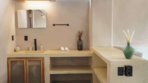 Modern full bathroom stocked with essentials: plush towels, shampoo, conditioner, and body soap for your convenience.