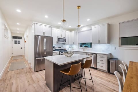Kitchen: Embrace your inner chef in our fully stocked kitchen, equipped with modern appliances and everything you need to stay in and prepare delicious meals. The spacious countertops make cooking a breeze.