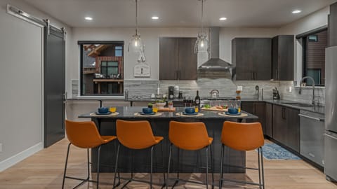 Main level gourmet kitchen with breakfast bar seating