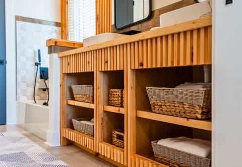 Wooden Vanity with Wicker Baskets Below for Storage
