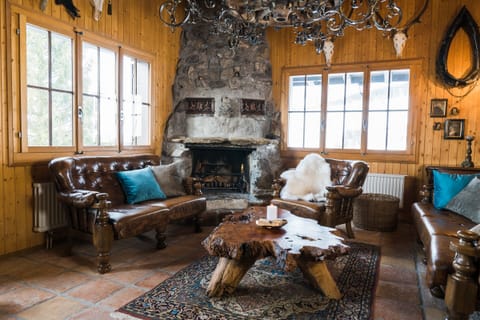 Rustically furnished living room with a fireplace