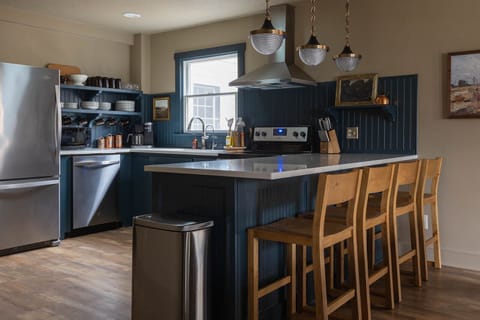 Fully stocked kitchen with room for 4 at the counter bar.