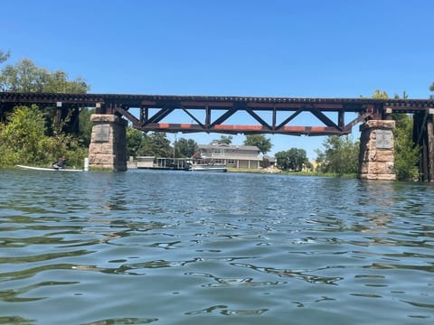 Train trestle bridge is no longer active.  Fun to jump off or watch people come by boat for a quick jump.