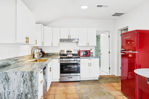 Marble, waterfall edge countertops with full size appliances.