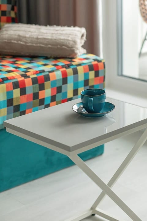 A close-up of a patterned bench with a coffee tray, adding a cozy and elegant touch.


