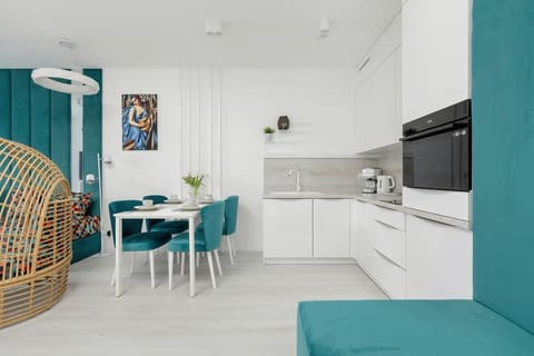A fully equipped kitchen and dining space, featuring a bright and airy layout.

