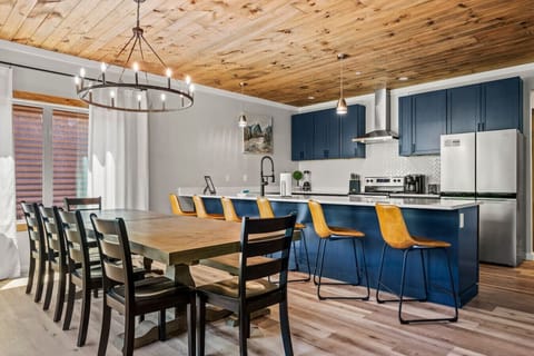 Luxury kitchen area with dining table that seats 10. There is additional seating for 6 at the countertop bar.