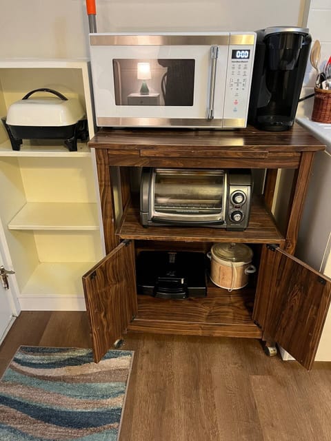 Fridge, microwave, coffee/tea maker, cookware/dishes/utensils