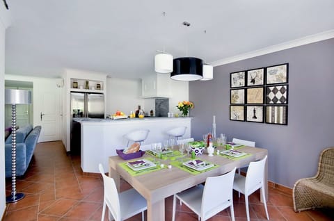 Our dining area features a spacious table, perfect for enjoying memorable meals with family and friends.