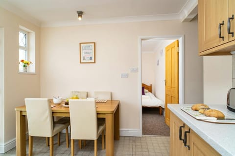 Kitchen and dining area with table and four chairs