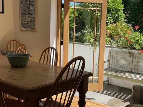 Dining area with table and chairs and double doors leading to the garden