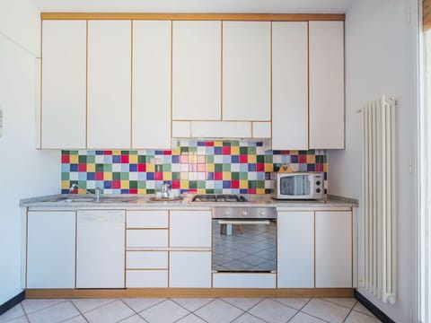 Cabinetry, Building, Kitchen, Flooring, Kitchen Appliance, Countertop, Floor, House, Kitchen Stove, Wood