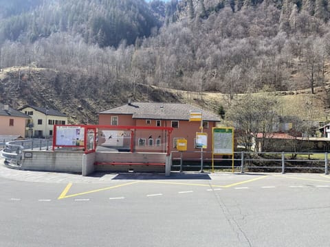 Mountain, Building, Tree, Asphalt, Vehicle, Road Surface, Sky, Landscape, Road