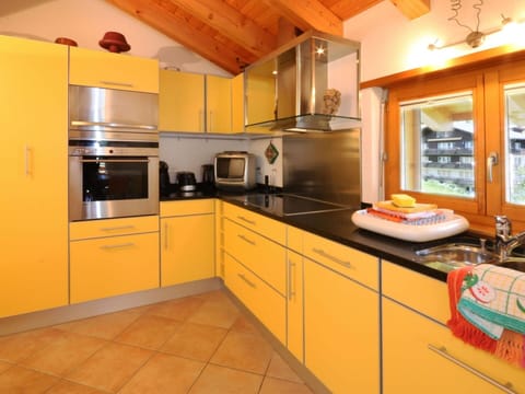 Countertop, Cabinetry, Property, Kitchen Appliance, Kitchen, Kitchen Stove, Sink, Wood, Home Appliance, Lighting