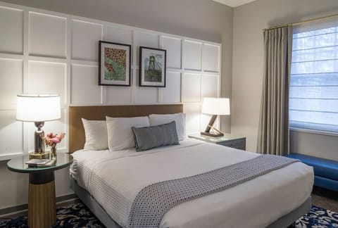 Drift off in crisp linens framed by elegant wall panels.