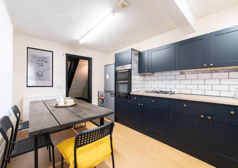 Dining area within the kitchen featuring:
- Oven
- Stove
- Washer
- Microwave
- Toaster
- Electric kettle
- Iron and ironing board