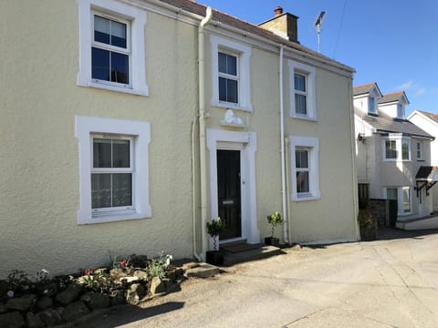Front of White Lion, front door, road and small flower bed