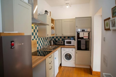 Kitchen with fridge/freezer, base and wall cupboards